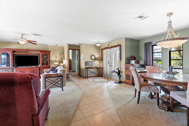 tiled living room with ceiling fan