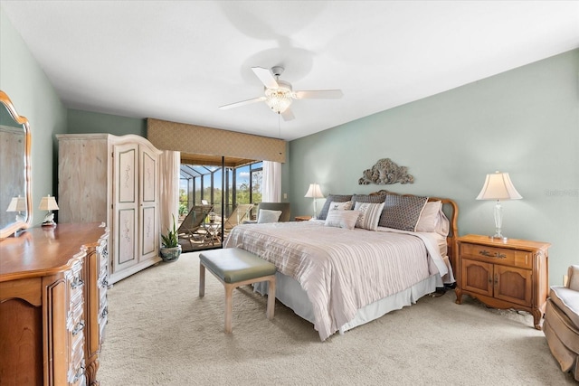 bedroom featuring access to outside, light colored carpet, and ceiling fan