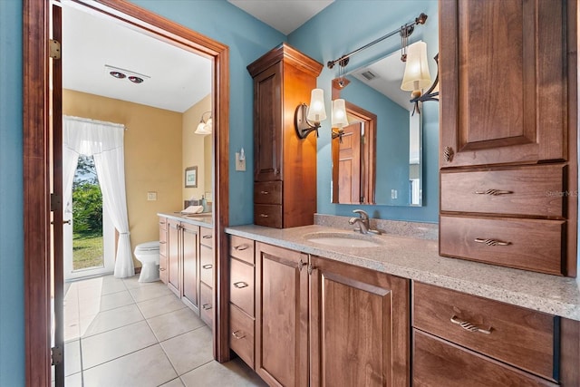 bathroom with tile patterned flooring, vanity, and toilet