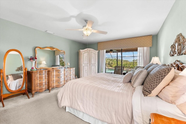 bedroom with access to outside, light colored carpet, and ceiling fan