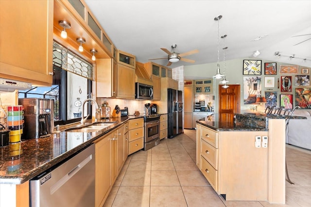 kitchen with a kitchen bar, sink, light tile patterned floors, appliances with stainless steel finishes, and pendant lighting