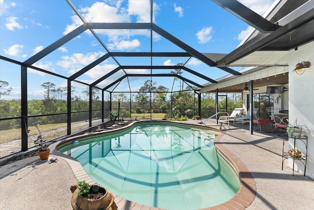 view of pool featuring a patio area, ceiling fan, and glass enclosure