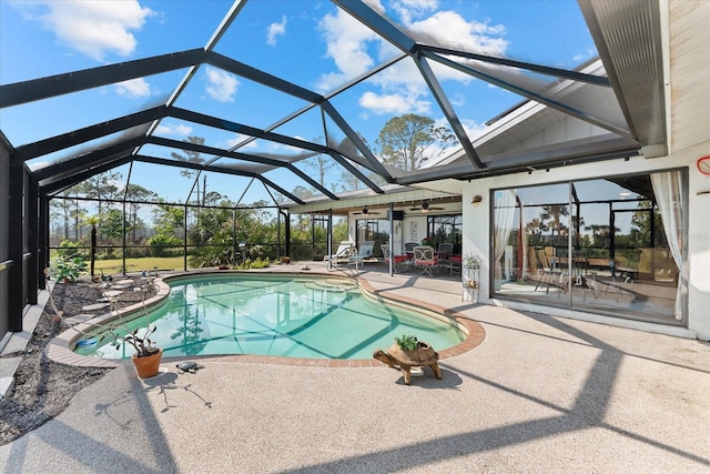 view of pool with a lanai, ceiling fan, and a patio area