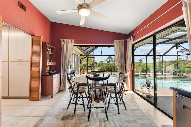 tiled dining area with ceiling fan and vaulted ceiling