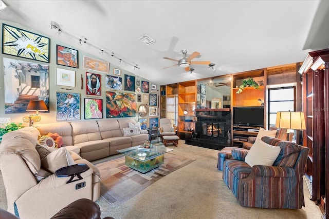 living room with carpet, track lighting, lofted ceiling, and ceiling fan