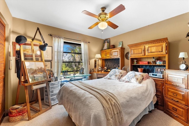 bedroom with ceiling fan and light colored carpet