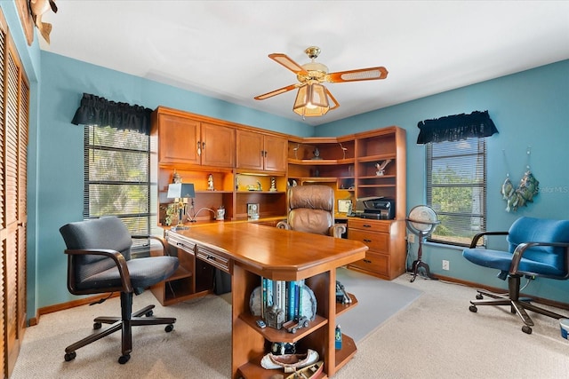 carpeted home office with ceiling fan