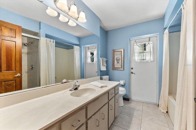 full bathroom with tile patterned floors, vanity, toilet, and a wealth of natural light