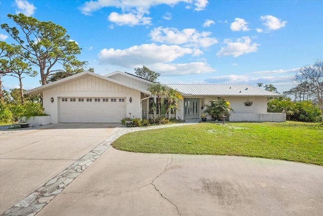 ranch-style house featuring a garage and a front lawn