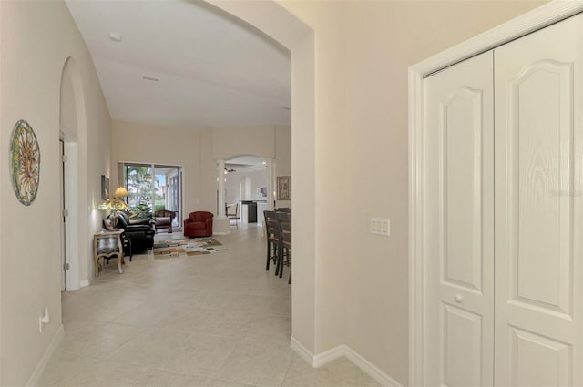 hall with light tile patterned floors