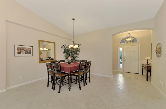 tiled dining room with vaulted ceiling and a chandelier