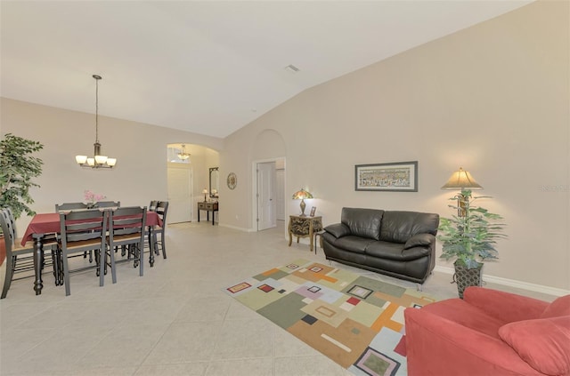 living room featuring light tile patterned flooring, a chandelier, and vaulted ceiling