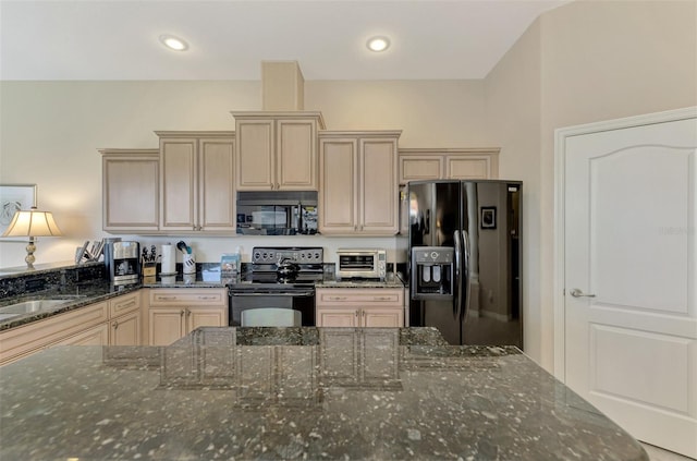 kitchen featuring sink, dark stone countertops, and black appliances