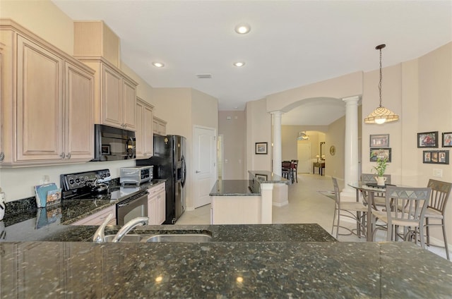 kitchen featuring pendant lighting, decorative columns, sink, black appliances, and light brown cabinets