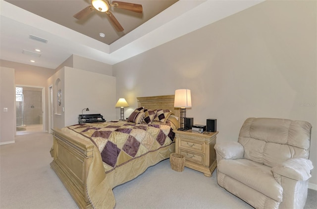 carpeted bedroom featuring ceiling fan and ensuite bath