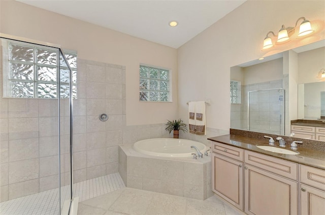 bathroom with shower with separate bathtub, vanity, and tile patterned floors