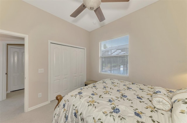 carpeted bedroom with ceiling fan and a closet