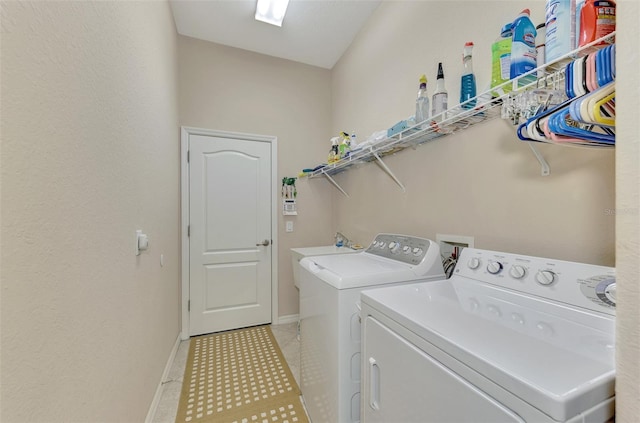 clothes washing area with washer and clothes dryer