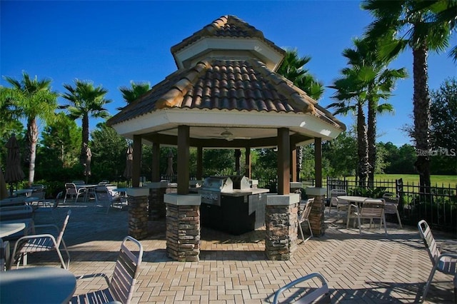 view of home's community featuring a gazebo, area for grilling, exterior bar, and a patio area