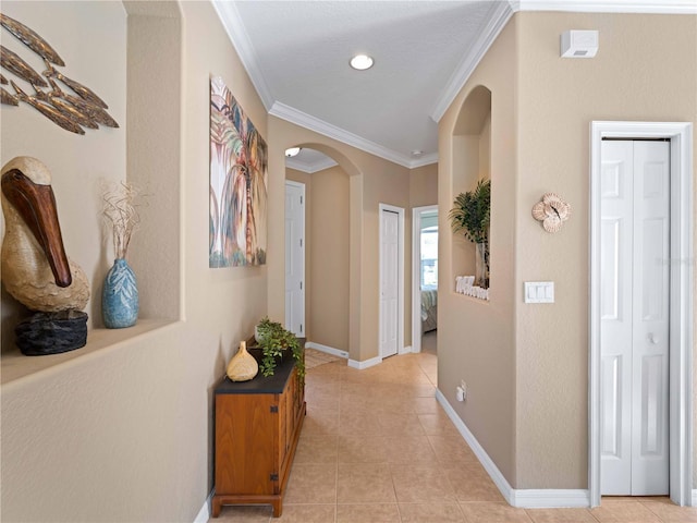 hallway featuring light tile patterned flooring and ornamental molding