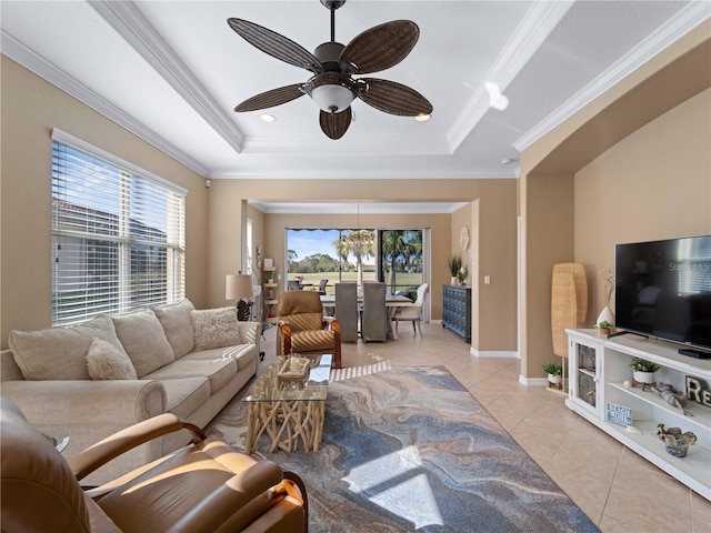 living room featuring crown molding, ceiling fan, a tray ceiling, and light tile patterned floors