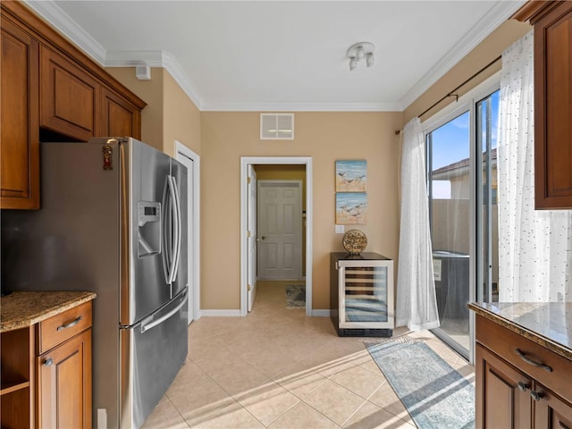 kitchen with crown molding, wine cooler, stainless steel fridge, and light stone counters