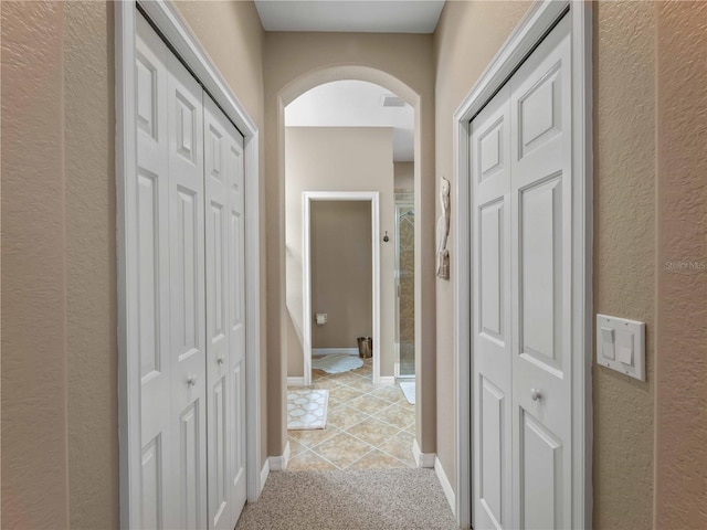 hallway featuring light tile patterned floors