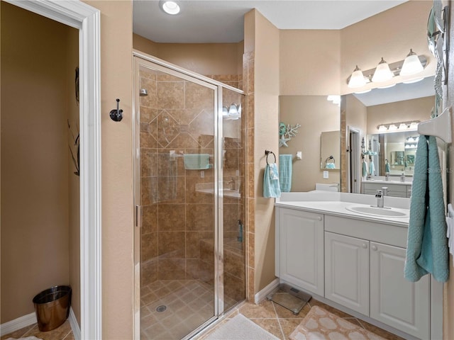 bathroom with tile patterned floors, vanity, and an enclosed shower