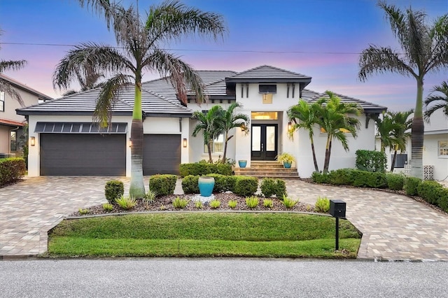 view of front of house with a garage and french doors