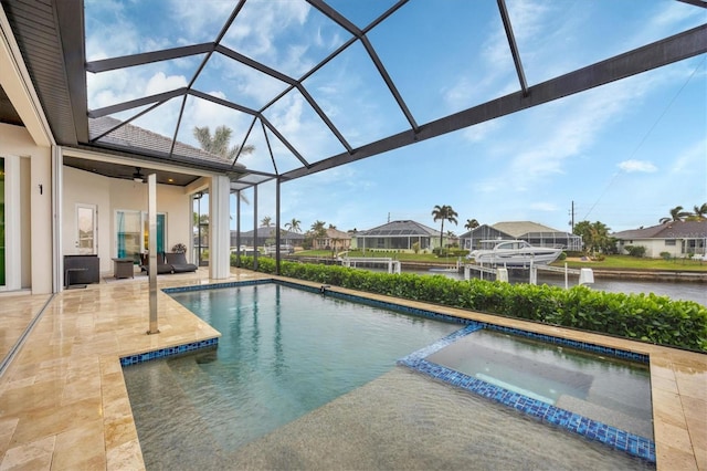 view of swimming pool with glass enclosure, an in ground hot tub, a patio area, and ceiling fan