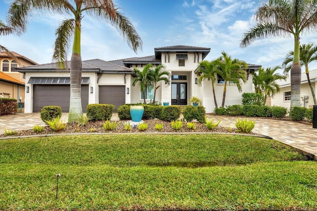 view of front of house with a garage and a front yard