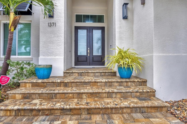 view of exterior entry featuring french doors