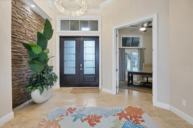 foyer with crown molding and french doors