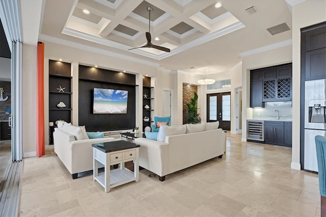 living room with indoor wet bar, built in shelves, wine cooler, crown molding, and coffered ceiling