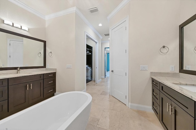 bathroom with crown molding, a tub, and vanity