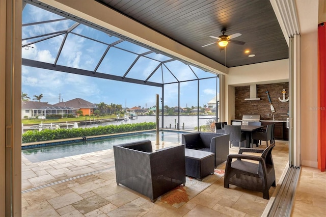 view of patio / terrace featuring a water view, grilling area, and a lanai