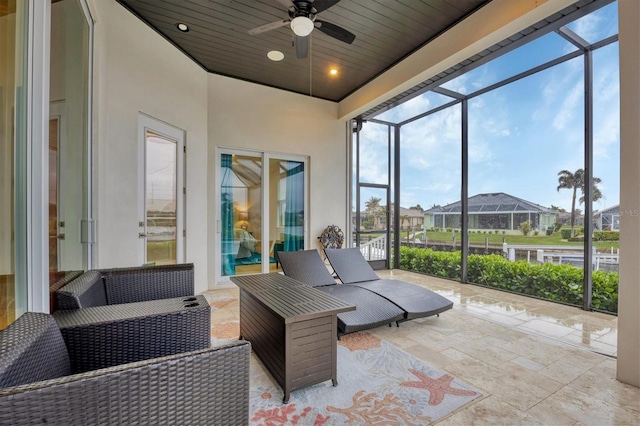 sunroom / solarium with ceiling fan and wood ceiling