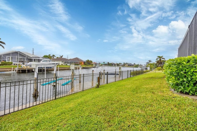 view of yard with a dock and a water view