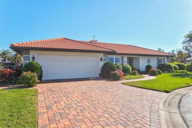 view of front of house with a garage and a front lawn