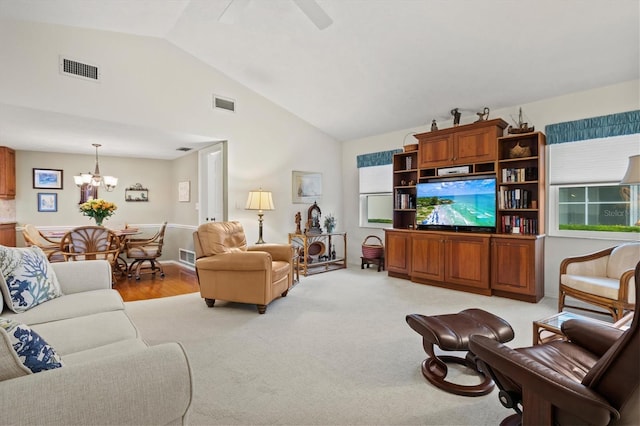 carpeted living room featuring lofted ceiling and an inviting chandelier