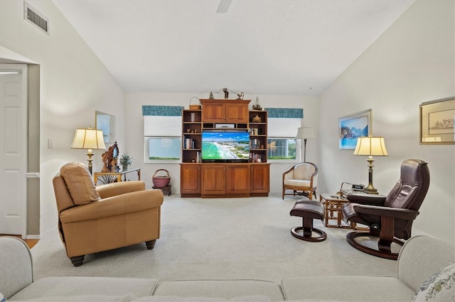 carpeted living room featuring vaulted ceiling