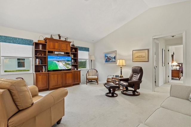 carpeted living room with vaulted ceiling