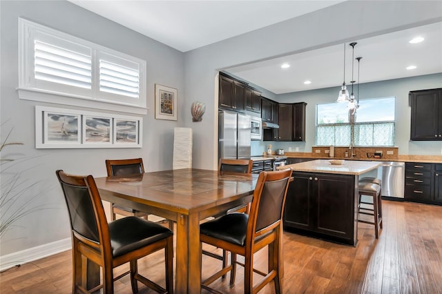 dining area featuring sink and hardwood / wood-style floors