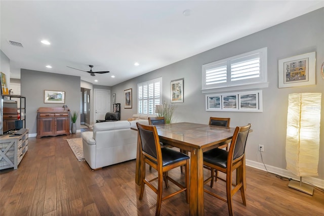 dining space featuring ceiling fan and dark hardwood / wood-style flooring