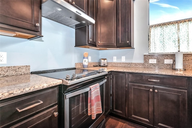 kitchen with stainless steel range with electric stovetop and dark brown cabinetry