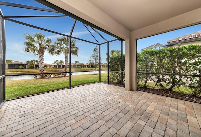 unfurnished sunroom featuring a water view