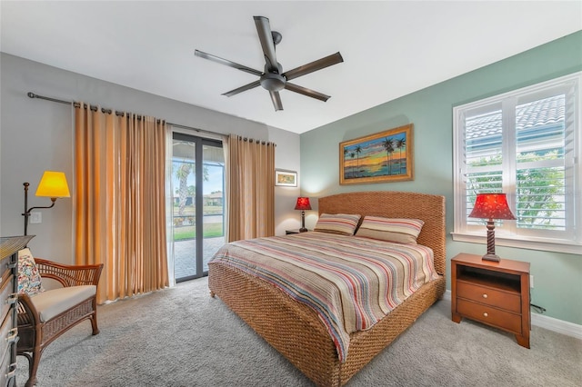 bedroom featuring access to outside, light colored carpet, ceiling fan, and multiple windows