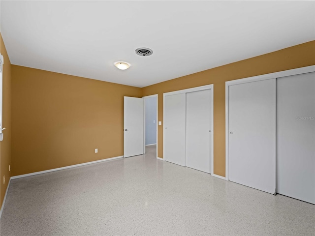 unfurnished bedroom with multiple closets