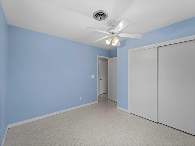 unfurnished bedroom with ceiling fan and a closet