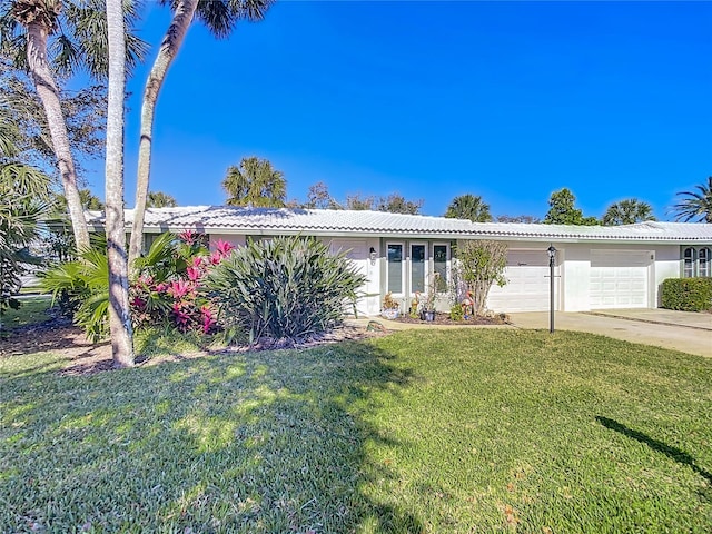 ranch-style house with a garage and a front lawn